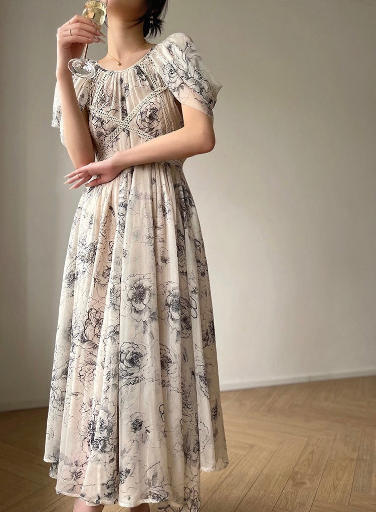 Woman wearing a floral dress in a minimal indoor setting