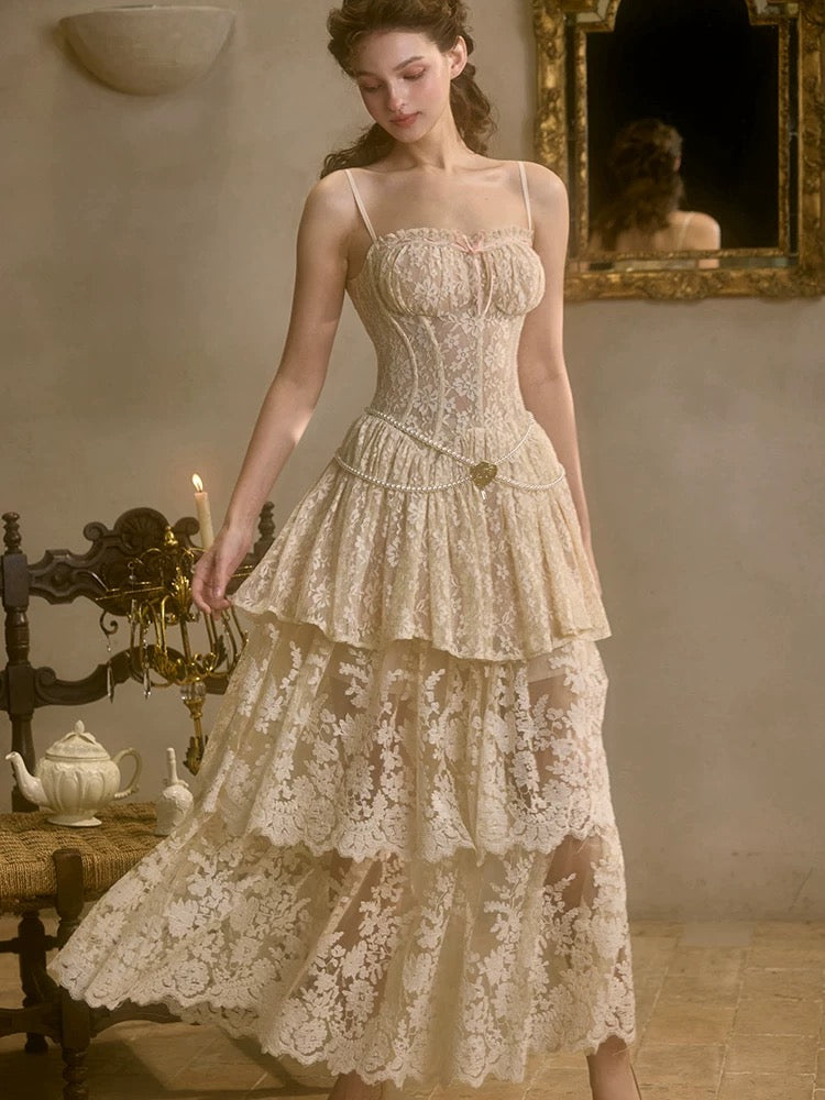 A woman in a vintage-style beige mini dress with gold lace, featuring a structured bodice and a flared skirt with a double-layered hem.