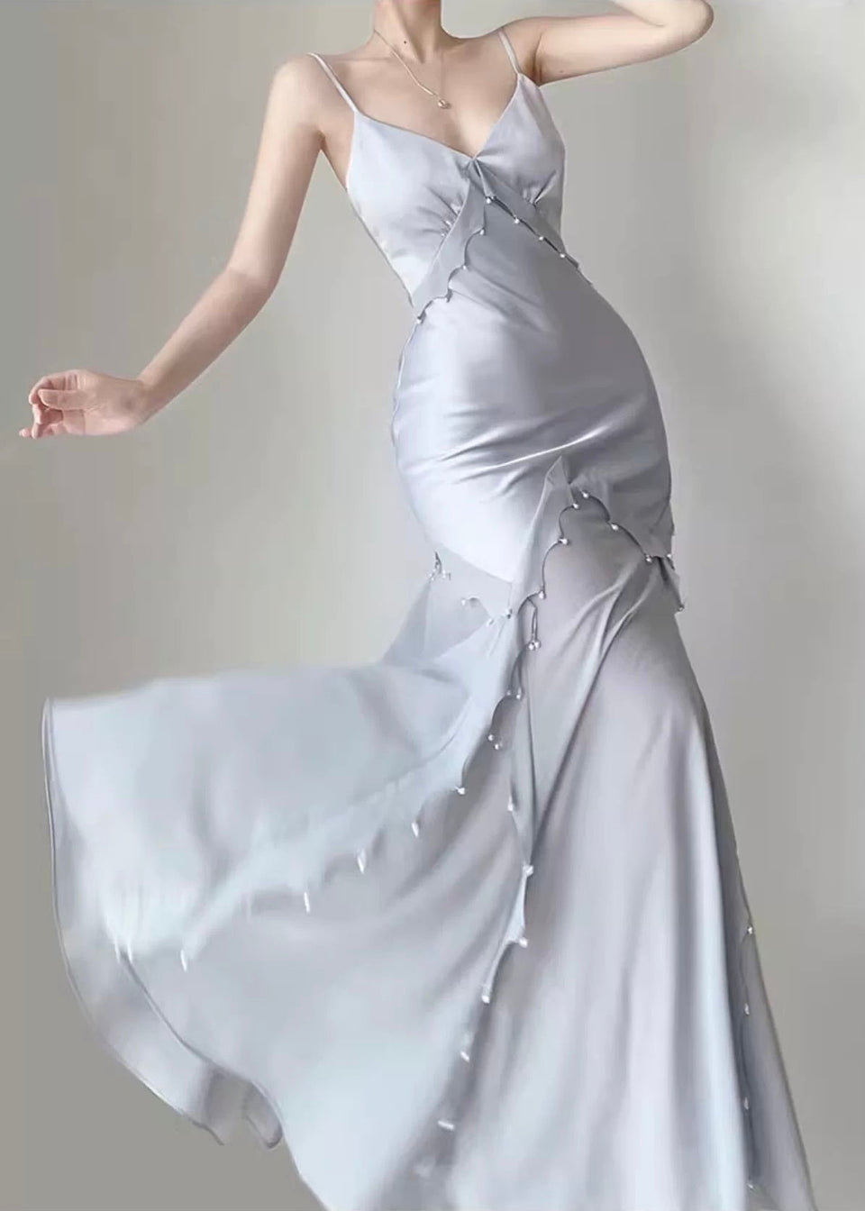 Silver evening gown with a plain background
